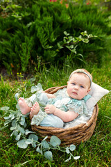 Cute little girl in a beautiful flowering shrub in the park in summer