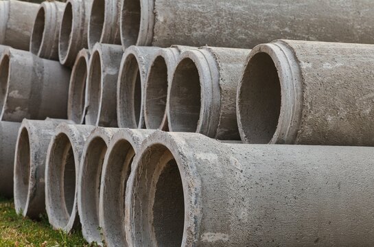 Macro view of concrete pipes stacked up high.
