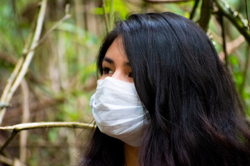 Face of a young white woman with black hair and wearing a mask