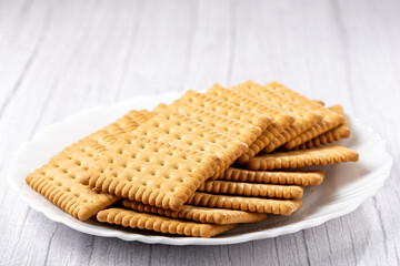 Plate with cornstarch biscuit on the table.
