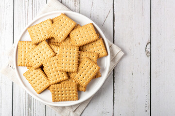 Plate with cornstarch biscuit on the table.