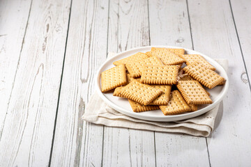 Plate with cornstarch biscuit on the table.