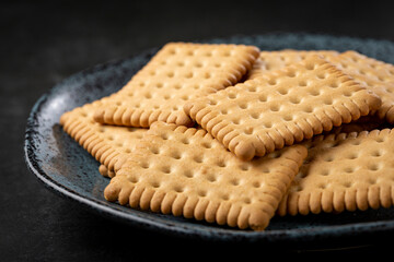 Plate with cornstarch biscuit on the table.