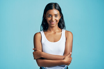 Confident and content. Studio portrait of a beautiful young woman standing with her arms crossed...