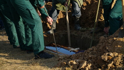Funeral ceremony. People come to say goodbye. Burial in the grave.