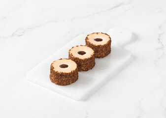 Coffee sweet round sushi on a serving board. Light background