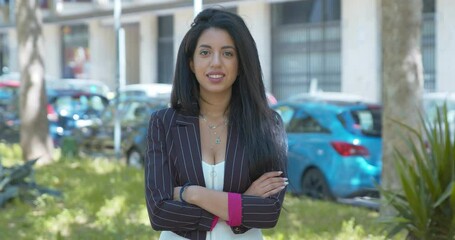 beautiful moroccan businesswoman crosses her arms smiling at camera