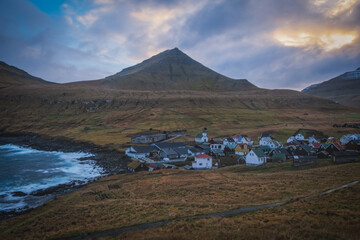 Gjogv village on the island of Eysturoy, Faroe Islands. Scandinavian colored houses. November 2021, sunset time.