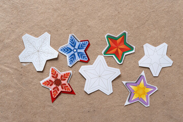 Fototapeta na wymiar set of decorative stars (halftone pattern) on plain brown paper