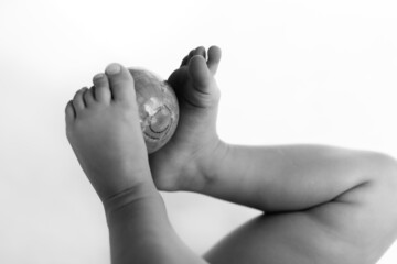 Fototapeta premium Cute little girl holding World Globe on her legs, white background