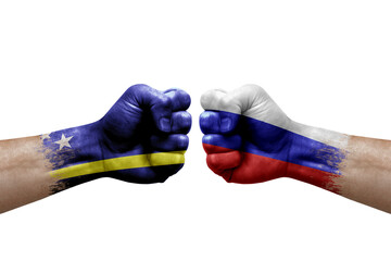 Two hands punch to each others on white background. Country flags painted fists, conflict crisis concept between curacao and russia