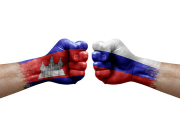 Two hands punch to each others on white background. Country flags painted fists, conflict crisis concept between cambodia and russia