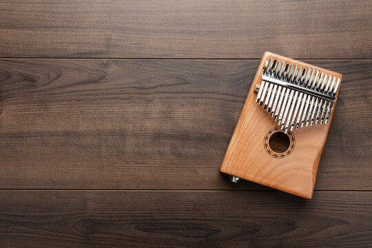 Overhead photo of mbira instrument with copy space. Wooden kalimba on the wooden background.