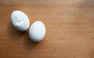 cracked eggs on wooden table