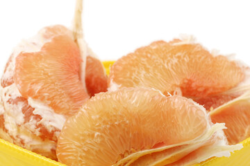 peeled pomelo pieces isolated on white background. Tasty fresh fruit eating concept