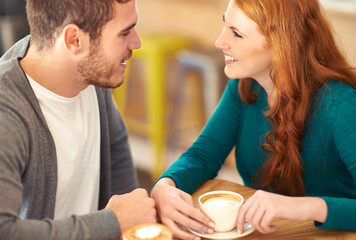 Fresh young love. A cropped shot of a young affectionate couple on a coffee date.