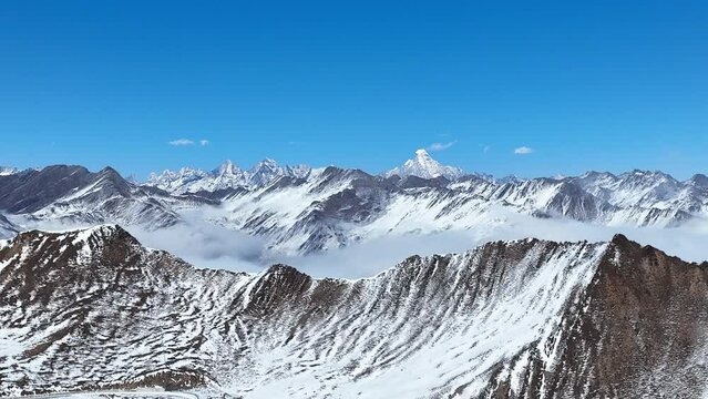 Snow landscape of Four girls Mount Siguniang Mountain in SIchuan CHina Aerial pan right 4k footage