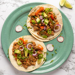 Ground beef tacos with avocado and bell peppers. Mexican food