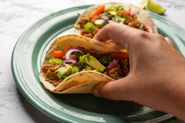 Ground beef tacos with avocado and bell peppers. Mexican food