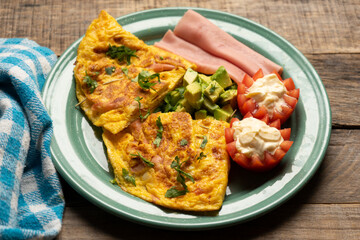 Ham omelette with avocado and tomato