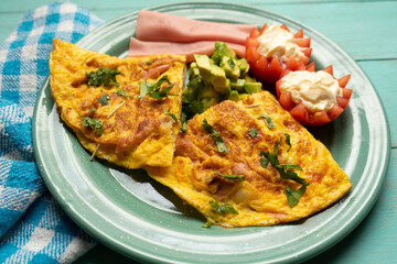 Ham omelette with avocado and tomato