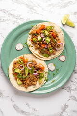 Ground beef tacos with avocado and bell peppers. Mexican food