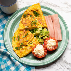 Ham omelette with avocado and tomato