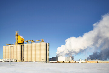 A large concrete grain shipping terminal in a Canadian rural winter landscape