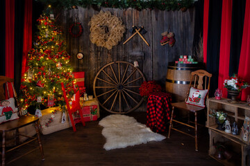 An indoor Christmas scene with a lit Christmas tree set up for portrait sessions