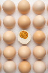 a half cut egg in the center of many eggs