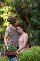 Naklejka na ściany i meble The garden of love. Shot of a happy young couple enjoying a day of gardening.