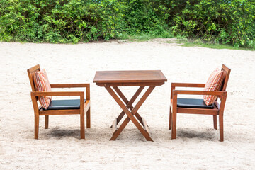 wood chairs and table on the beach in hotel