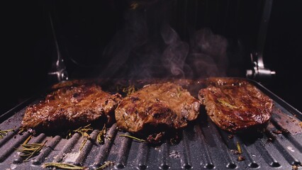 Delicious juicy meat steak cooking on grill. Aged prime rare roast grilling tenderloin fresh marble...