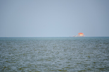 The ocean view with small Buddhist temple in Thailand.