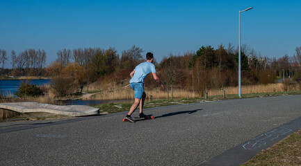 Man skateboarding in the park on a spring day