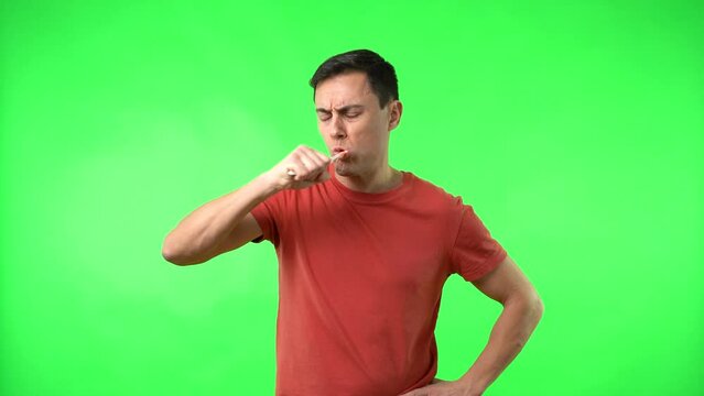 Male in red t shirt brushing teeth