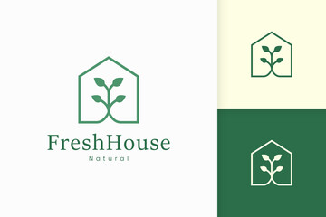 Nature green house logo with tree and leaf shape