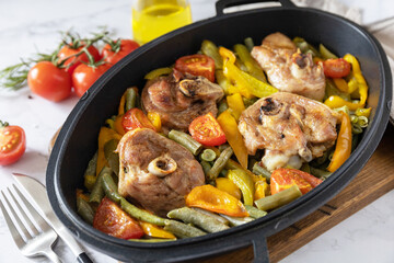 Baked turkey meat steaks with spices and vegetables on a marble tabletop. Grilled sliced Turkey steaks in a pan. Breast fillet.