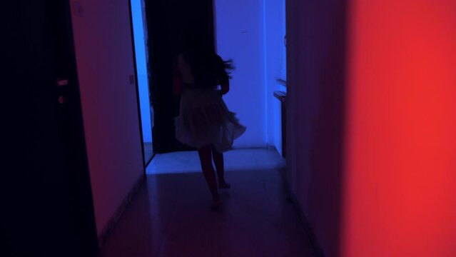 danger, fear - scared indian woman runs in the dark to escape an assault