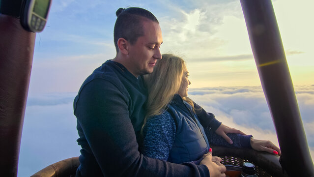 Adventure love couple on hot air balloon with morning sky