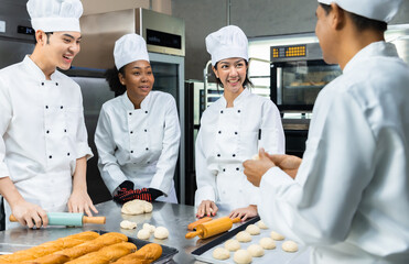 Asian Chefs  baker in a chef dress and hat, cooking together in kitchen.Team of professional cooks in uniform preparing meals for a restaurant in the kitchen.