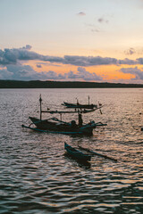 sunset over the ocean, fishing boats. Bali, Indonesia