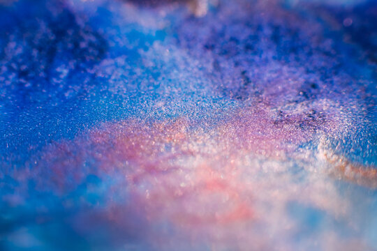 Ink blend. Artistic hobby. Colorful abstract bakgrund. Blue purple pink glitter paints mix