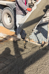 Pouring cement or concrete with a concrete mixer truck, construction site with a reinforced...