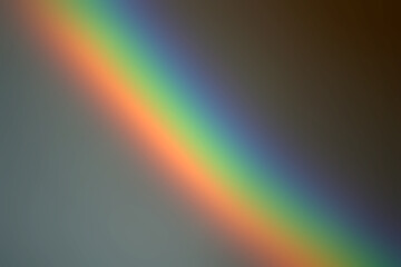 Abstract oblique rainbow blurred background. The phenomenon of visible light scattering through the glass. Physics spectrum of light multicolor.