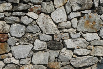The limestone wall is constructed by a gray wall for background or texture.