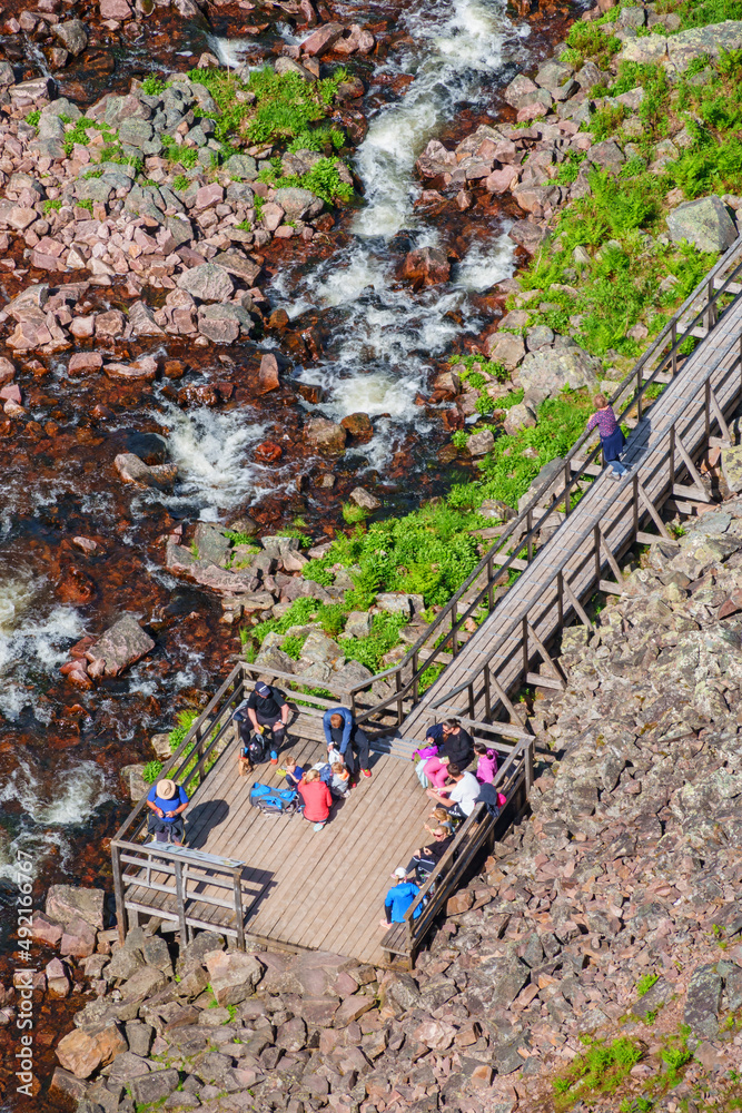 Wall mural Tourists on a outlook platform at a river