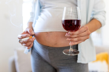 Smoking and alcohol pregnancy.woman on a long pregnancy drinking alcohol and Smoking...
