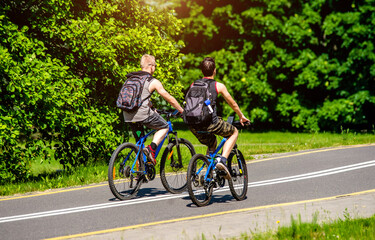 Obraz na płótnie Canvas Cyclists ride on the bike path in the city Park 