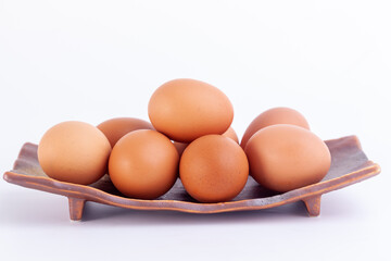 chicken eggs lies in a japaness ceramic saucer on white background.